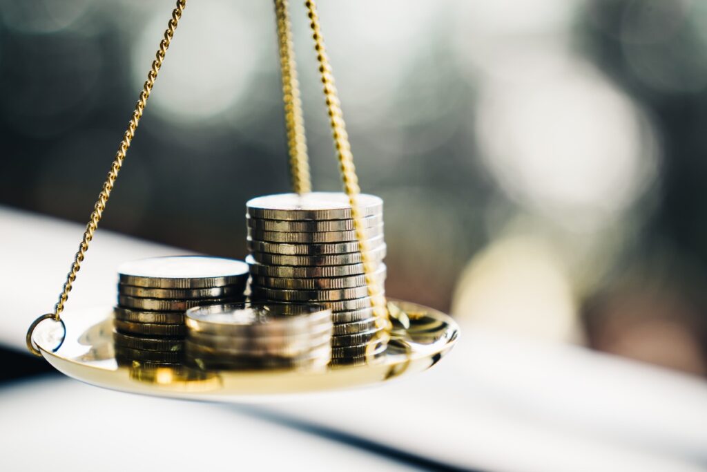 Coins stacked on balance scale