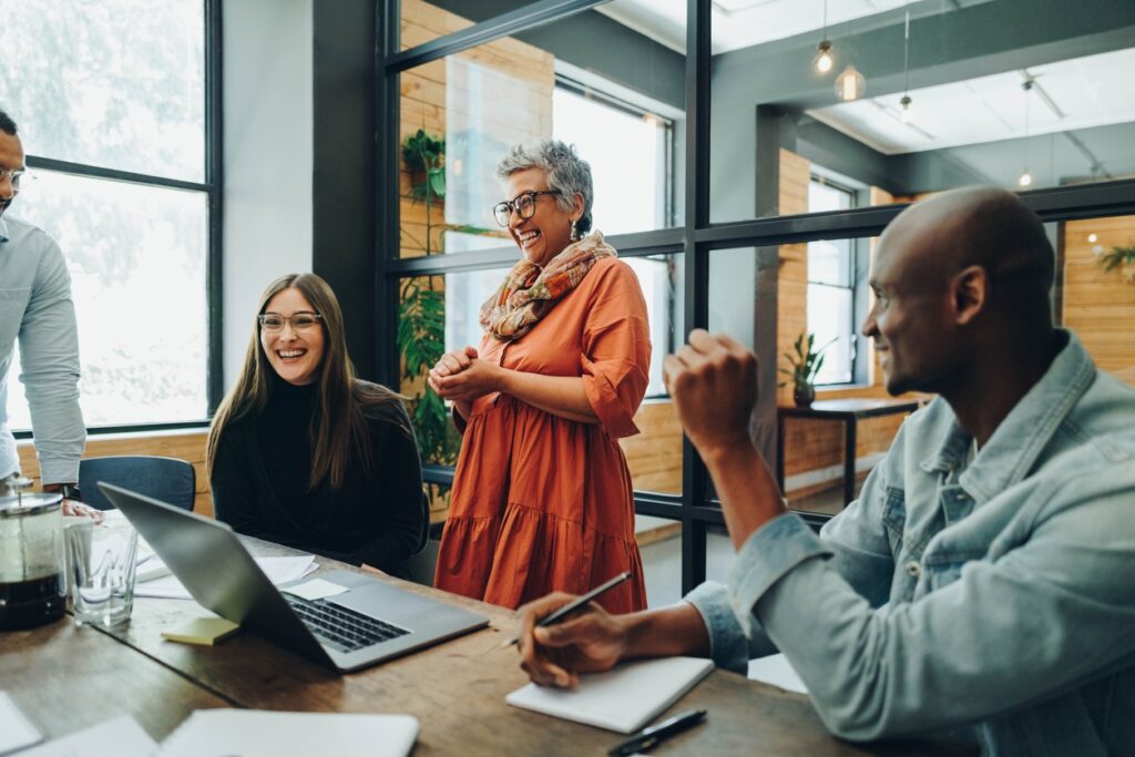 Diverse business people smiling cheerfully during an office meeting