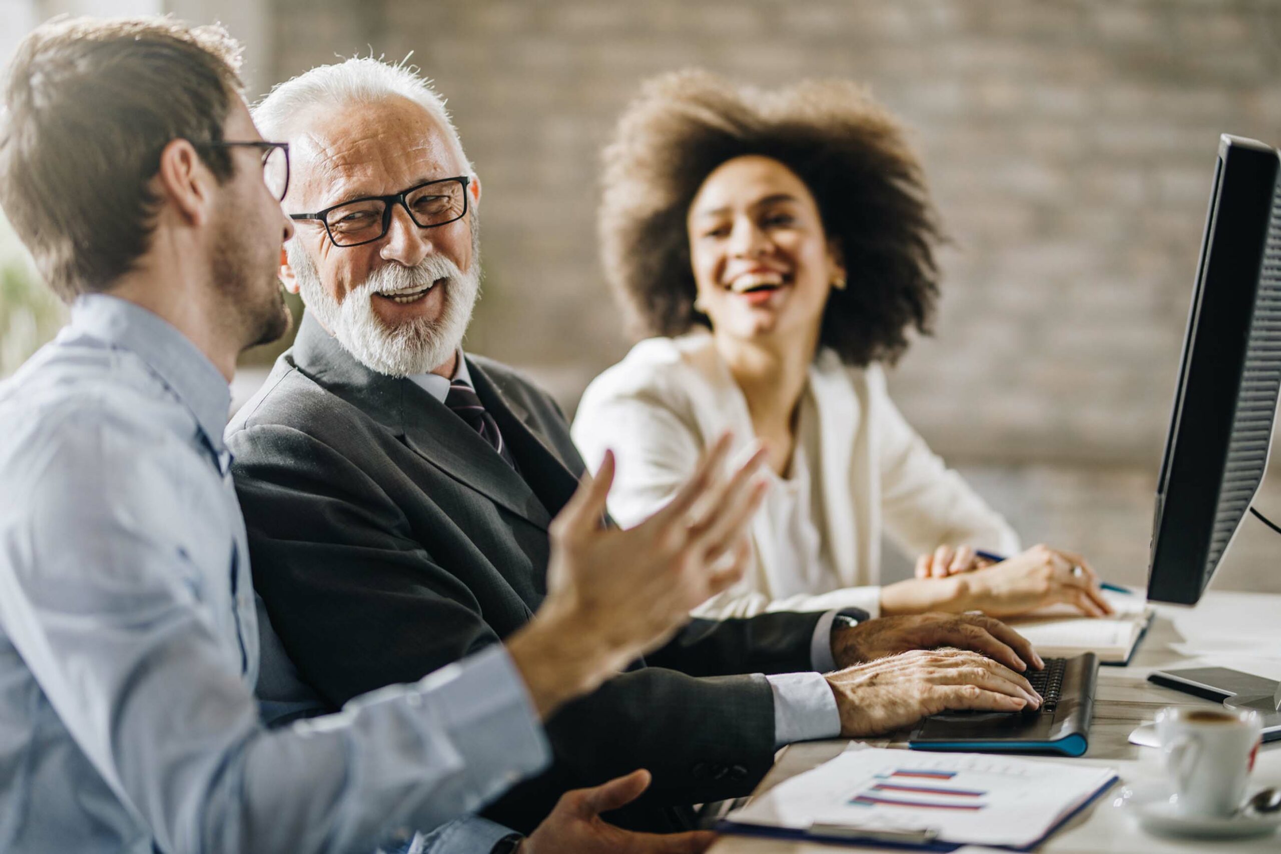 employees in meeting room laughing