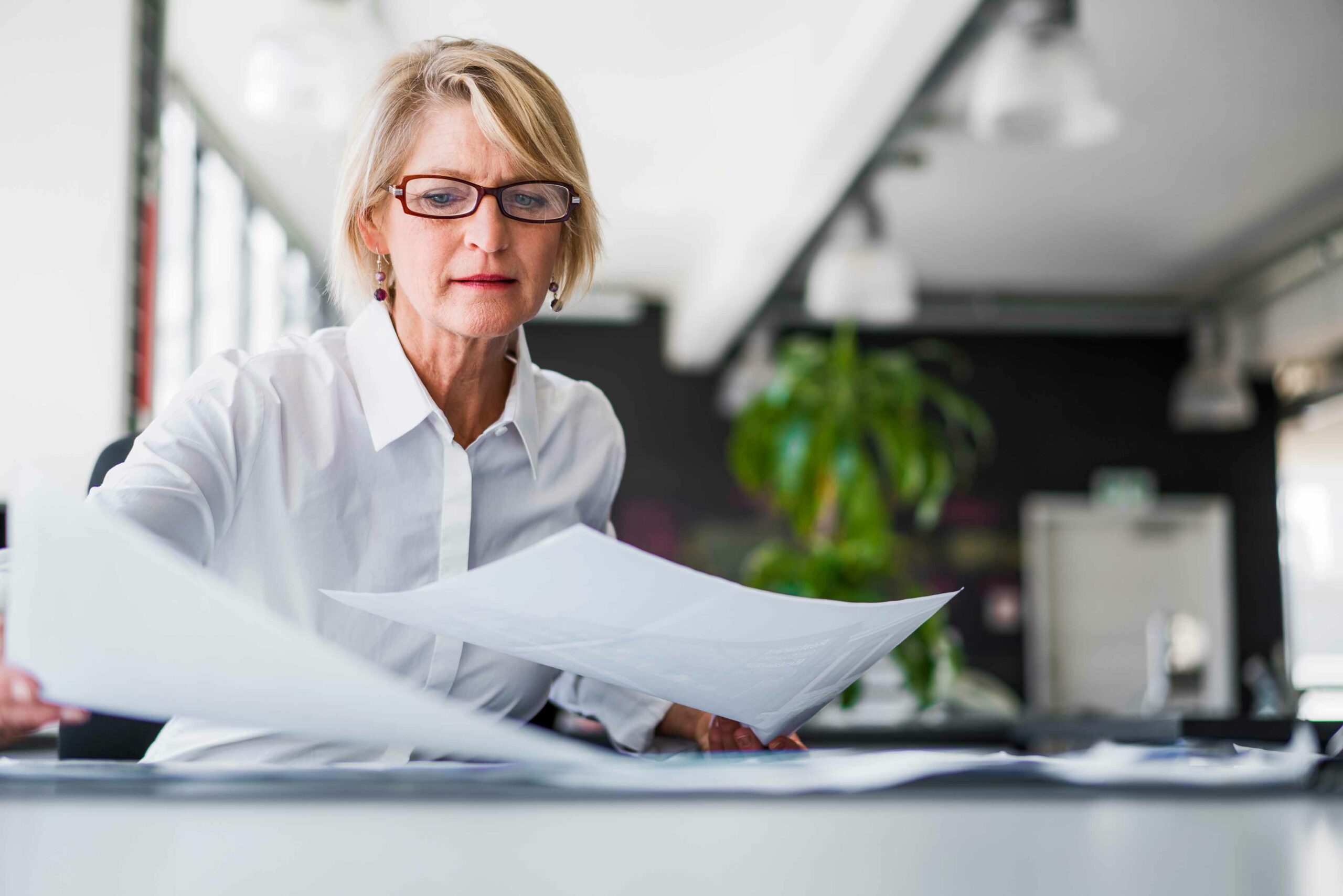 woman going through paperwork in office