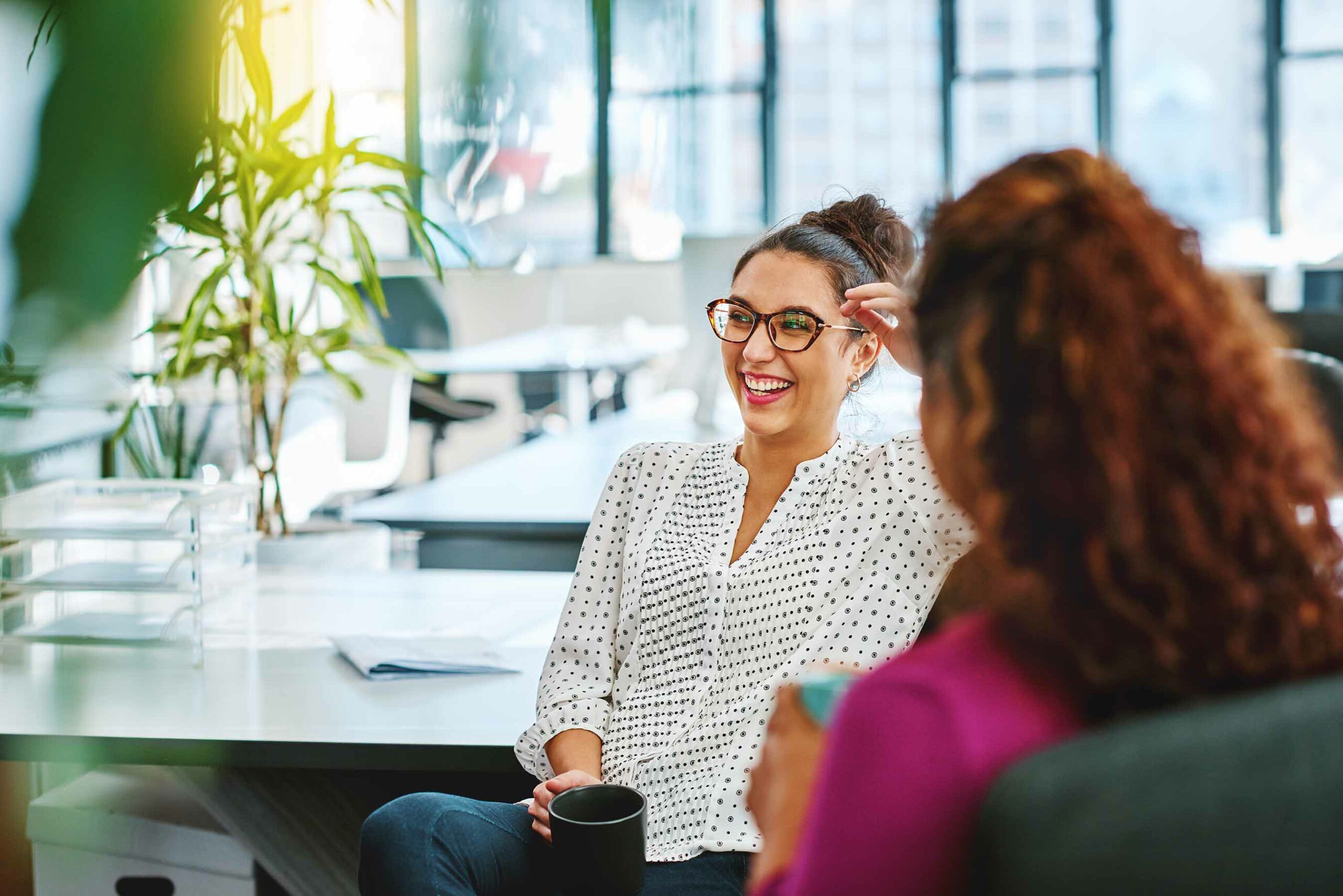 women laughing in office