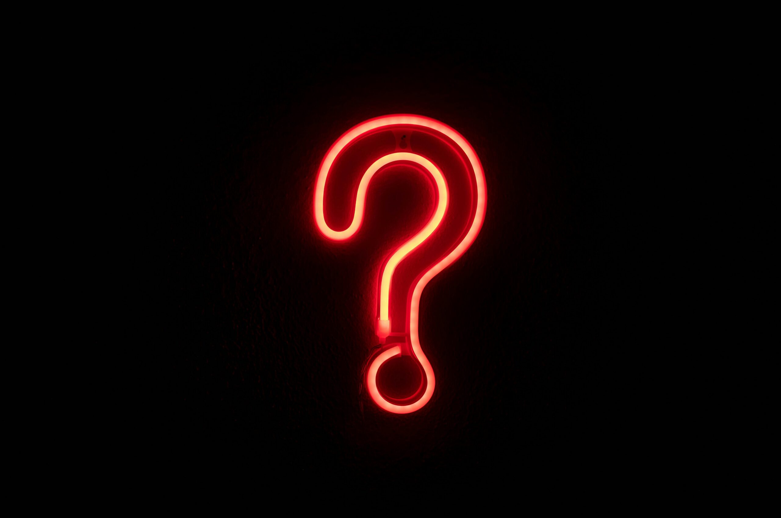 neon red question mark on a black background
