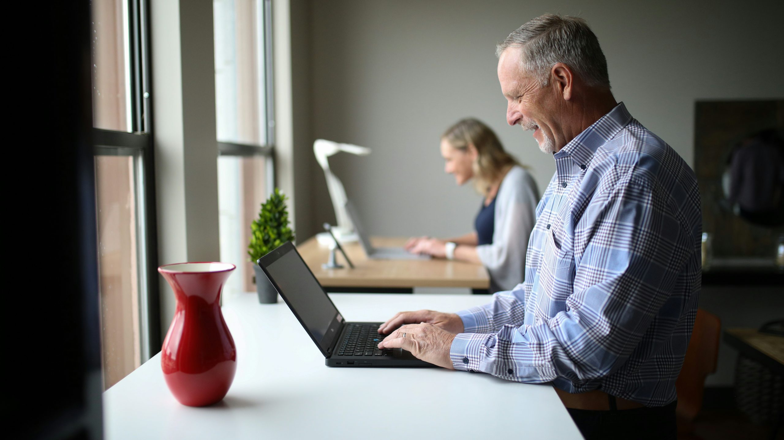 salary-sacrifice-auto-enrolment middle aged man working on laptop in office